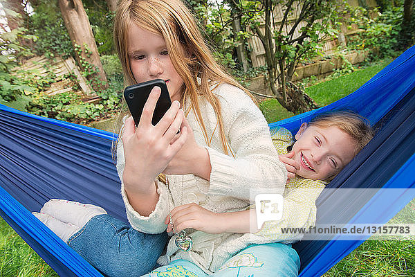 Children relaxing in hammock