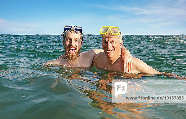 Portrait of two men swimming in sea