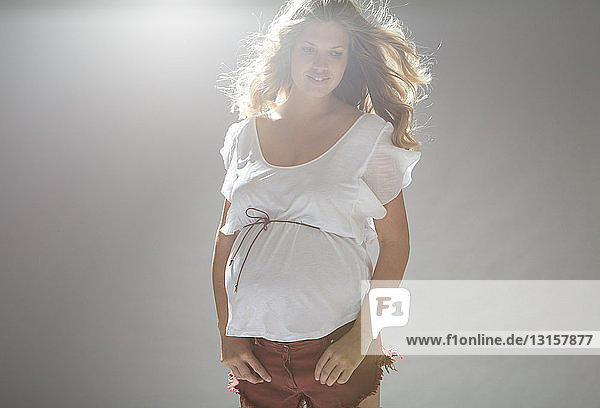 Studio portrait of pregnant young woman