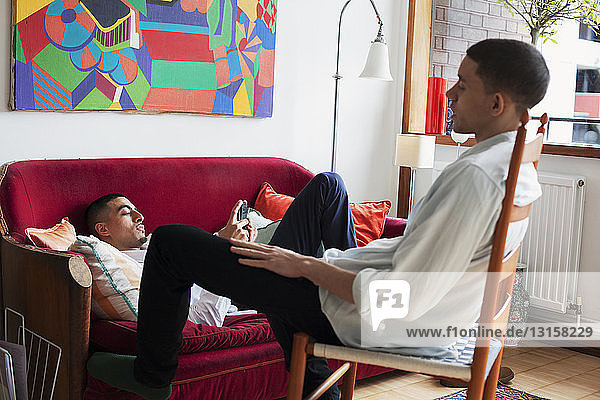 Young men relaxing in living room
