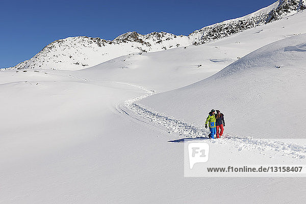 Couple walking in snow  Kuhtai  Austria