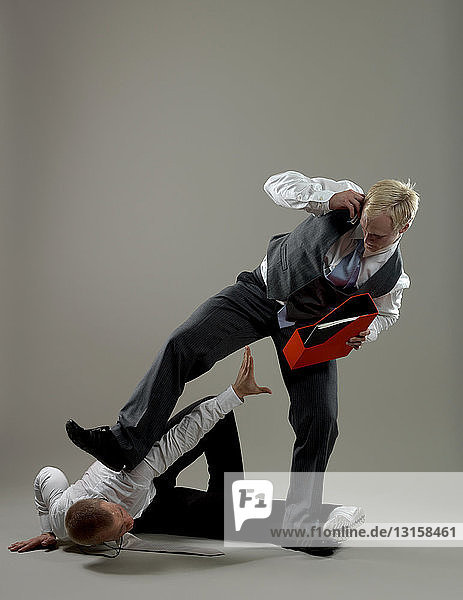 Business man fighting over paper holder