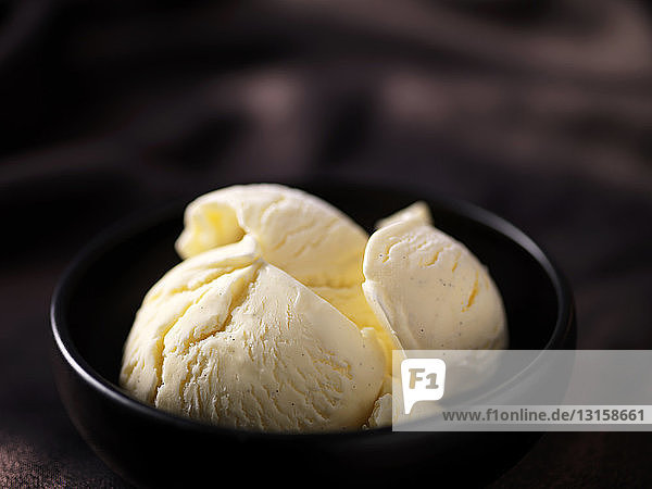 Clotted cream vanilla ice cream in black ceramic bowl