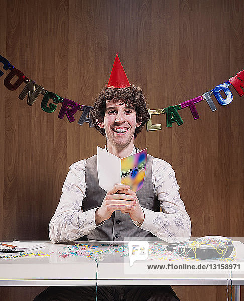 Geschäftsmann liest Geburtstagskarte