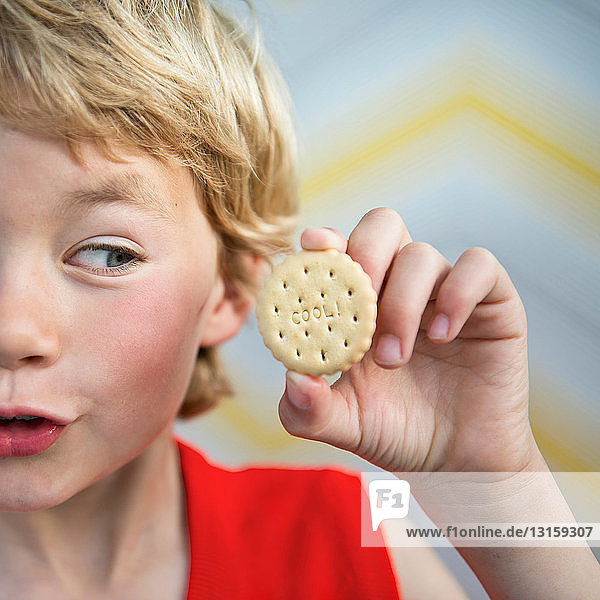 Boy holding cool biscuit