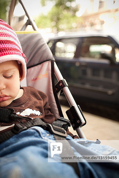 Toddler boy sleeping in stroller