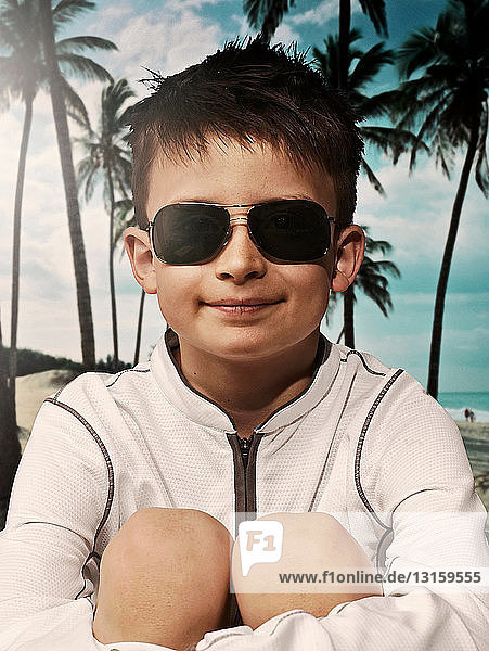 Boy wearing sunglasses on beach