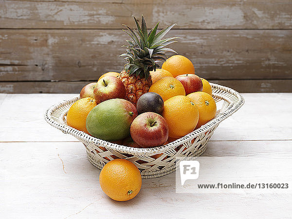 Basket of fresh fruit on wooden table