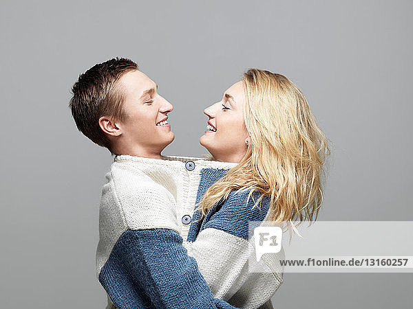 Young couple wearing same sweater