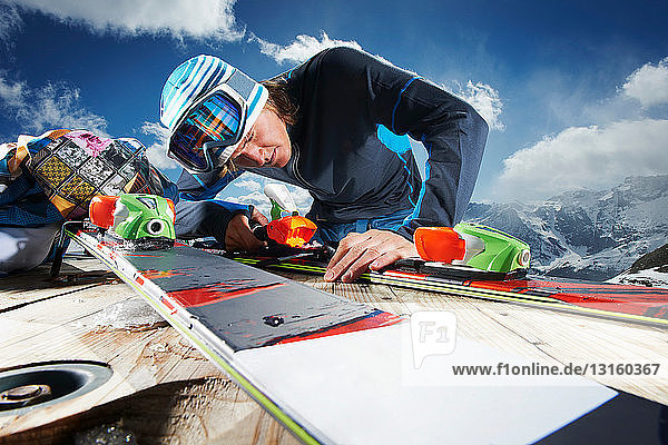 Male skier examining skis