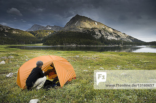 Man camping near Big Sandy Lake  Wind River Range  Wyoming  USA