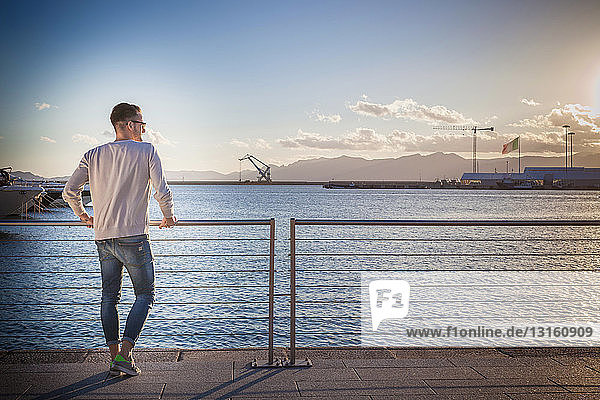 Young man relaxing by port  Cagliari  Sardinia  Italy