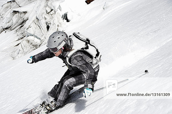 Female skier speeding downhill