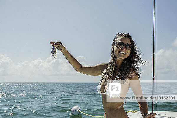 Young woman on boat holding fish  Islamorada  Florida Keys  USA