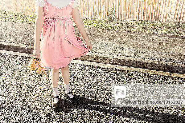 Abstract girl posing holding doll