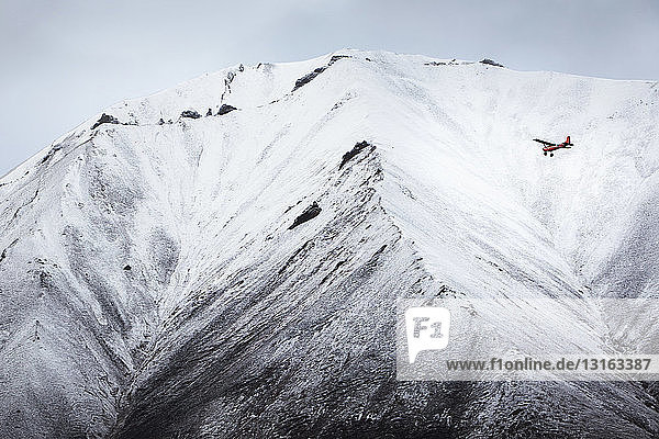 Airplane flying in front of snow covered mountain Wrangell St. Elias Alaska USA