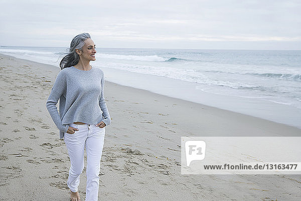 Mature woman walking on beach  Los Angeles  California  USA