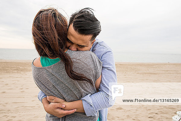 Young couple hugging at beach