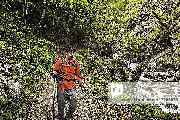 Young man hiking on river path  Oberstdorf  Bavaria  Germany