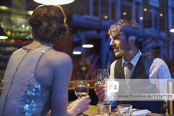 Couple holding wine glasses in restaurant