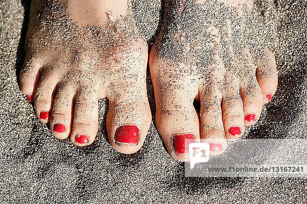 Close up of woman?s feet in sand