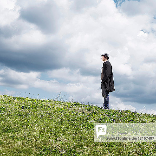 Lone man standing on hill