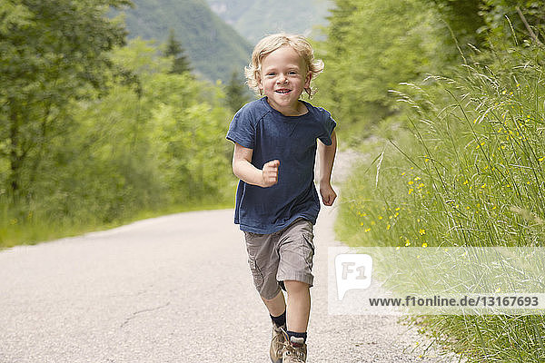 Boy running on rural road  Bovec  Soca  Slovenia