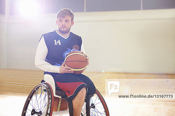 Wheelchair basketball player holding ball