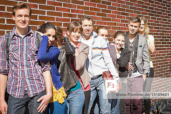 Friends posing together on city street
