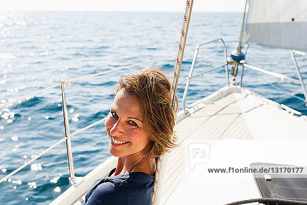 Lächelnde Frau sitzt auf Boot