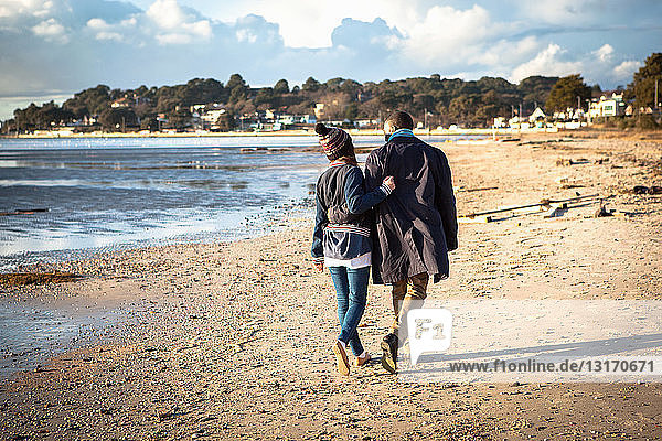 Romantic young couple strolling on the beach