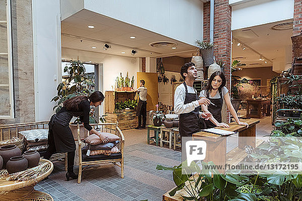 Male and female colleagues working at store