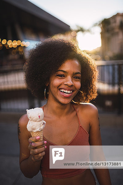 USA  Nevada  Las Vegas  portrait of happy young woman eating ice cream in the city