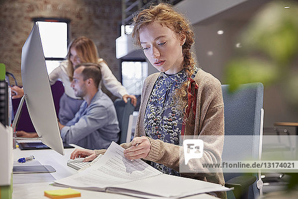Young woman working in modern creative office  usine laptop