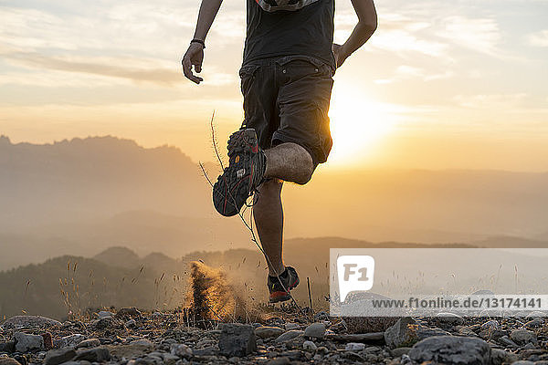 Spain  Barcelona  Natural Park of Sant Llorenc  man running in the mountains at sunset