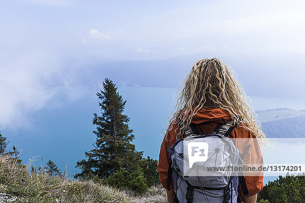 Young woman hiking in the Bavarian mountains  looking at Lake Walchensee
