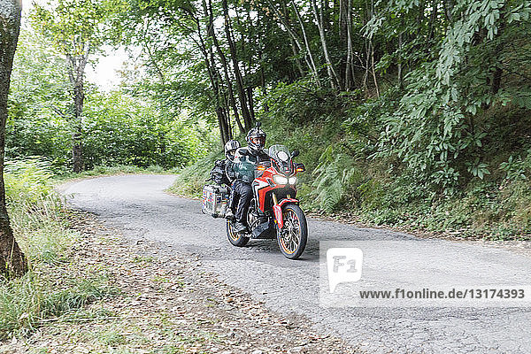 Father and son on a motorbike trip on a country road