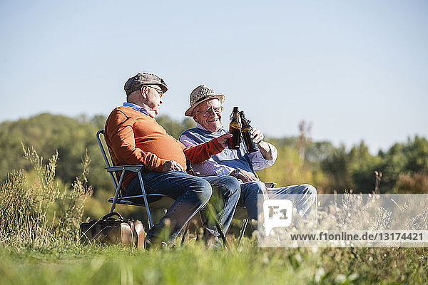 Two old friends sitting in the fields  drinking beer  talking about old times
