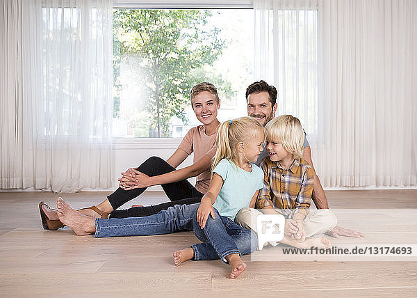 Relaxed family sitting on the floor at home