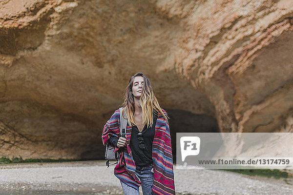 Spain  Alquezar  young woman on a hiking trip in front of rock formation