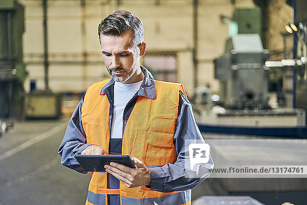 Man using tablet in factory
