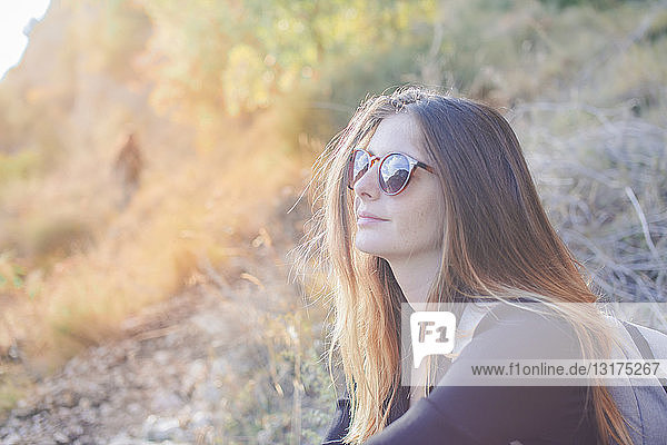 Young woman on a hiking trip wearing sunglasses