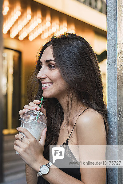Smiling young woman with smoothie
