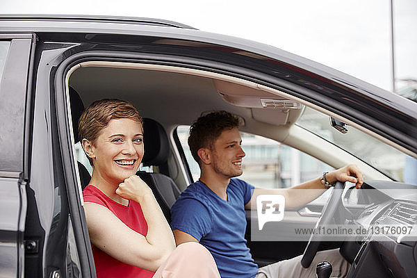 Happy young couple in a car