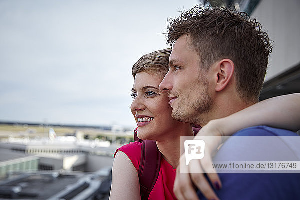 Glückliches Paar auf der Aussichtsplattform des Flughafens