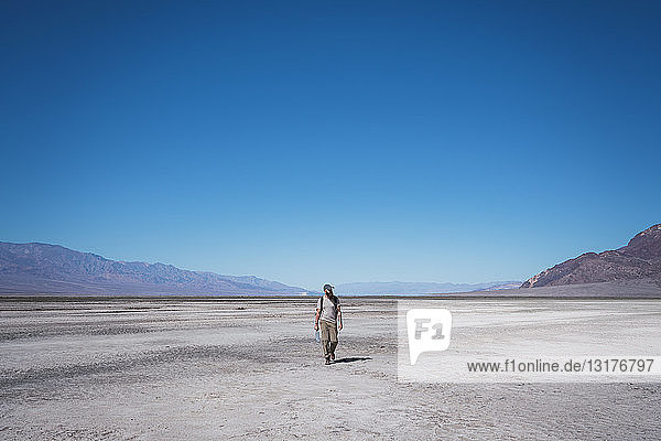 USA  California  Death Valley  man walking in desert