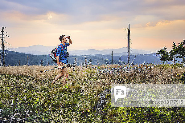 Man hiking in the mountains at dusk
