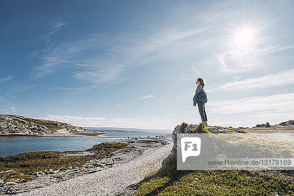 Finland  Lapland  woman standing at the coast in backlight