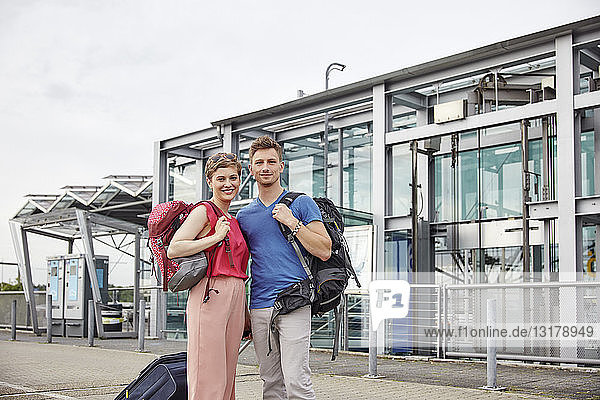 Portrait of smiling couple outside airport