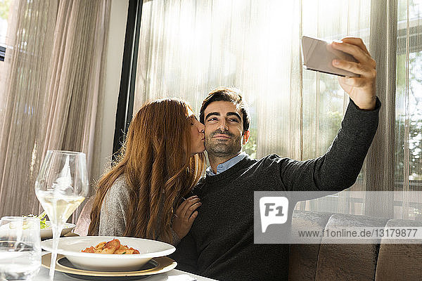 Couple in love taking a selfie in a restaurant
